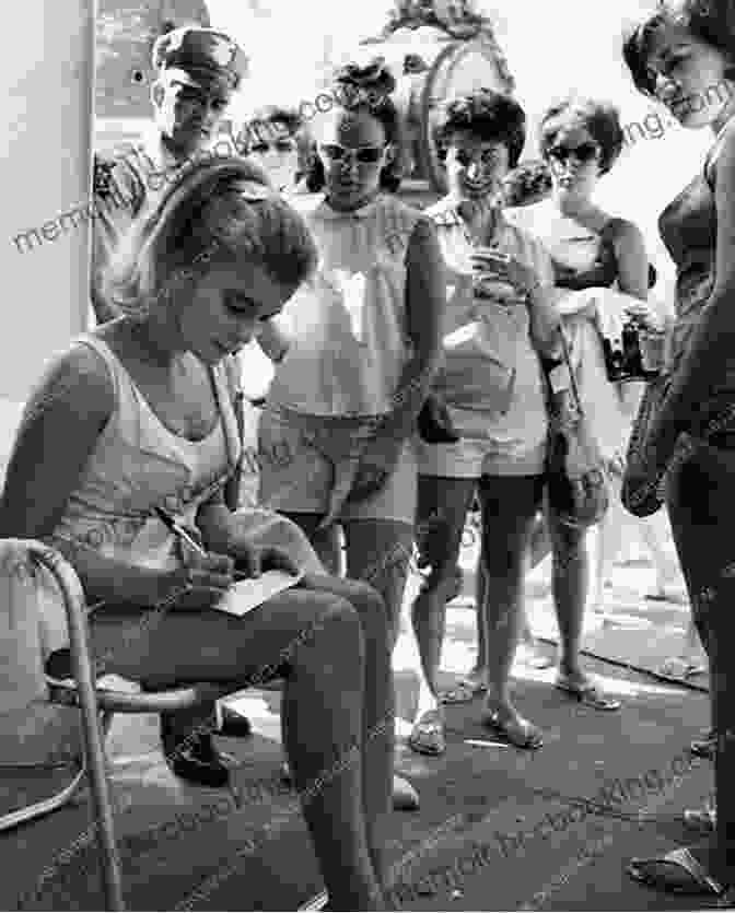 A Candid Photograph Of Ann Marks Signing Copies Of Her Memoir, Surrounded By Admiring Fans And Well Wishers An Unusual Life Ann Marks